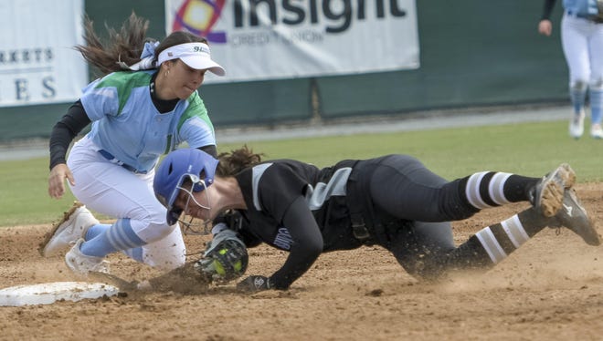 LSSC softball player Genesis Aviles (4) tags out a runner during Friday‘s game against St. Petersburg College in Leesburg. [PAUL RYAN / CORRESPONDENT]