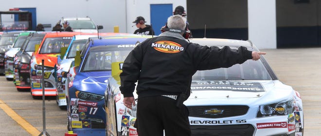 A track official motions drivers to the track for ARCA's first practice at Daytona International Speedway on Friday, Feb. 7, 2020. Expect the action to start this weekend at the track, with an ARCA race on Saturday and the Busch Clash on Sunday.  [News-Journal/David Tucker]