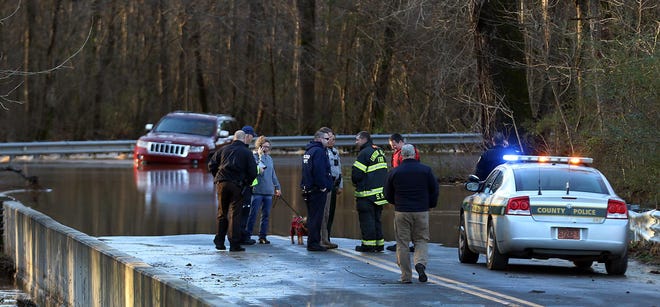 The driver and her dog were rescued from their vehicle after it got stuck in rising water on Thompson Road Friday morning, Feb. 7, 2020. [Mike Hensdill/The Gaston Gazette]