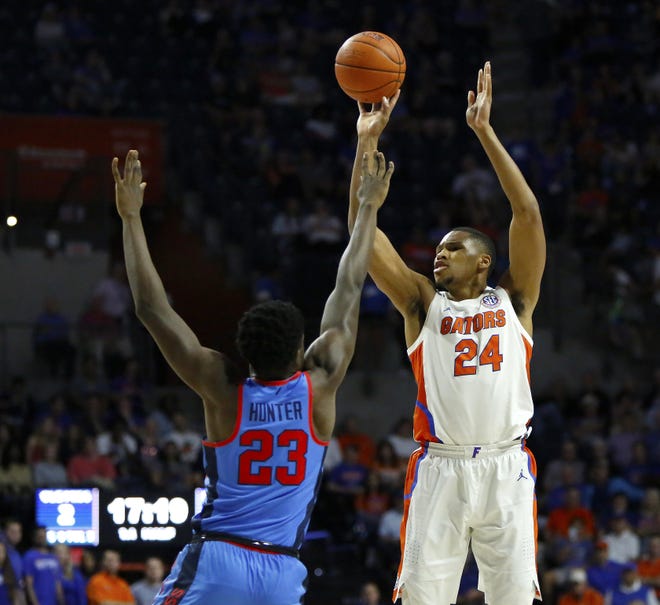 Florida center Kerry Blackshear shoots a 3-pointer over Mississippi forward Sammy Hunter during the Jan. 14 game at the O‘Connell Center. [Brad McClenny/Staff photographer]