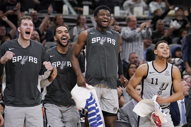Chimezie Metu, third from left, and San Antonio Spurs teammates celebrate a basket in a game against the Portland Trail Blazers in November. Metu led the Austin Spurs with 24 points in a win over Northern Arizona in the NBA G League on Friday night. [Darren Abate/The Associated Press]
