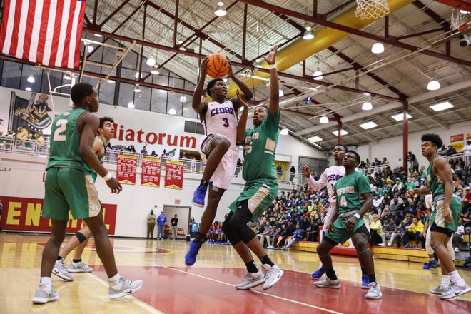 Cedar Shoals’ Tyler Johnson (3) takes a shot as Buford’s James Munlyn (25) attempts to block him during the Region 8-5A finals Friday night at Clarke Central High School. Buford won 88-86. (Photo/Gabriella Audi, for the Athens Banner-Herald)