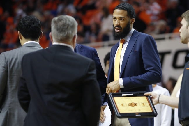 OSU assistant coach Cannen Cunningham walks on the court during a timeout earlier this season at Gallagher-Iba Arena. [Bryan Terry/The Oklahoman]