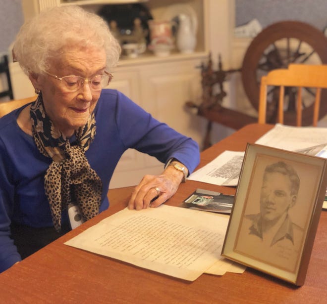 Twyler Boyce, 94, at home in Rumford, with the essay that her husband, John Boyce, wrote in 1946 about losing an eye to an enemy bullet during World War II. The sketch is of John during his recovery around that time. [The Providence Journal / Mark Patinkin]