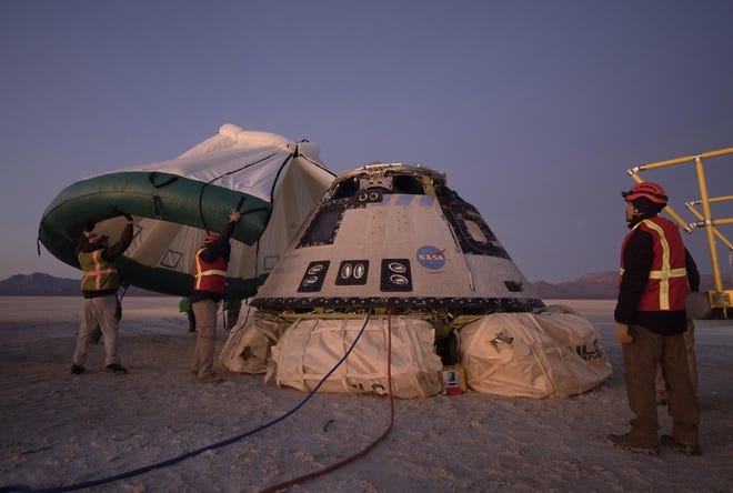 Boeing, NASA, and U.S. Army personnel work around the Boeing CST-100 Starliner spacecraft shortly after it landed Dec. 22 in White Sands, New Mexico. The landing completes an abbreviated Orbital Flight Test for the company that still meets several mission objectives for NASA’s Commercial Crew program. The Starliner spacecraft launched on a United Launch Alliance Atlas V rocket at 6:36 a.m. Dec. 20 from Space Launch Complex 41 at Cape Canaveral Air Force Station in Florida. [Bill Ingalls/NASA]