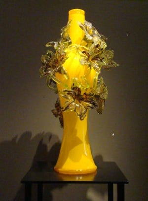 "Venetian Vase" is overwhelmed by sprouting flowers. Artwork © Chihuly Studio. All Rights Reserved.