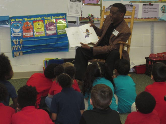 Pastor Nathan Mugala reads to a kindergarten class during Champion Elementary‘s African-American Read-In. (Photo provided)