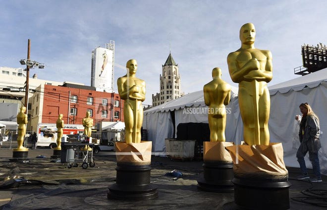 Oscar statues stand outside Hollywood Boulevard in preparation for Sunday's 92nd Academy Awards at the Dolby Theatre Wednesday in Los Angeles. (AP Photo/Chris Pizzello)
