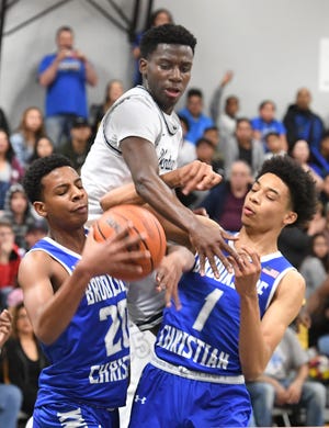 Venture Academy's Jaylen Lee goes for the block against Brookside Christian's Franlys Arias, left, and Ronnie Lee during the first half at Venture Academy. [CALIXTRO ROMIAS/THE RECORD]