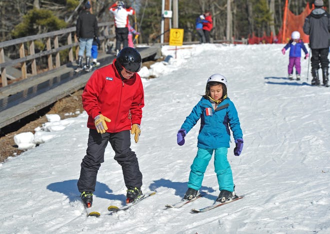 Blue Hills Ski Area instructor Alan Meyers gives some pointers to Eleanor Tansky, 7, of Newton during a ski lesson at the Blue Hills Ski Area in Canton. [Tom Gorman/For The Patriot Ledger]