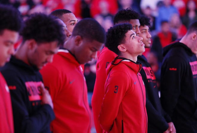 Ohio State freshman guard D.J. Carton listens to the national anthem prior to a Jan. 3 game against Wisconsin. [Adam Cairns]