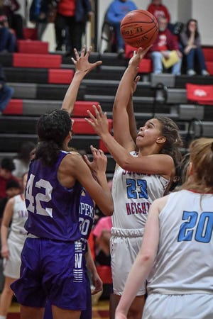 Shawnee Heights senior Kam Wells (23) shoots over Topeka West's McKinsey Jones (42) Tuesday night. Wells scored a game-high 21 points in the T-Birds’ 55-36 win. [Rex Wolf/Special to The Capital-Journal]