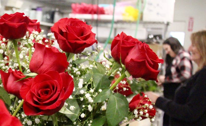 Floral designers assemble bouquets on Monday, Feb. 10, at Don's Flowers & Gifts in Zeeland in anticipation of Valentine's Day. Valentine's Day is the store's busiest single day. [Brian Vernellis/Sentinel staff]