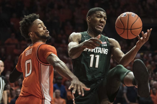 Michigan State's Aaron Henry (11) battles Illinois' Alan Griffin (0) for the loose ball in the second half of an NCAA college basketball game Tuesday, Feb. 11, 2020, in Champaign, Ill. (AP Photo/Holly Hart)