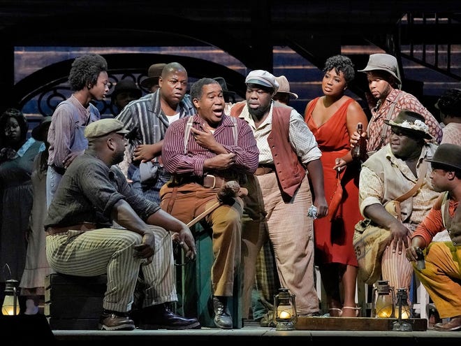 The cast of Gershwins' "Porgy and Bess," from left, Ryan Speedo Green (with cap) as Jake, Alfred Walker as Crown, Eric Owens as Porgy, Errin Duane Brooks as Mingo, Angel Blue as Bess, Reginald Smith Jr. (seated) as Jim and Chauncey Packer as Robbins. [KEN HOWARD/MET OPERA]