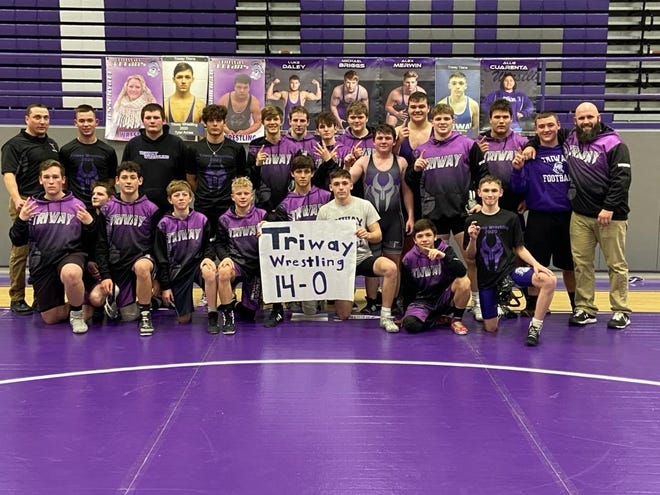 The Triway High School wrestling team poses for a photo after clinching its first undefeated season in program history on Tuesday.