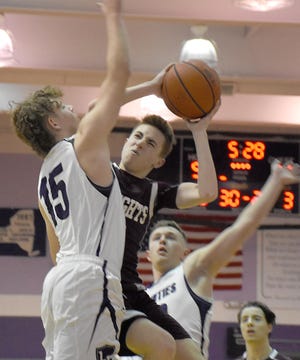 Frankfort-Schuyler’s Levi Spina goes up for a shot with Cole Cleary (15) defending for Little Falls during the second half of Thursday’s game. [Jon Rathbun / Times Telegram]