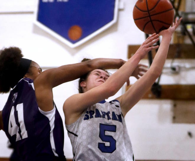 Scituate’s Rachel Oster gets fouled by Classical's Jasmine DePina going in for a layup on a fast break during Thursday night’s game. The Spartans edged the Purple, 45-43. [The Providence Journal / Kris Craig]