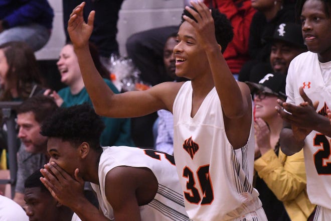 New Hanover's #30 Tyquan Williamson celebrates as New Hanover beat Hoggard 59-46 Thursday Feb. 13, 2020 at Brogden Hall for the MEC title .[KEN BLEVINS/STARNEWS]