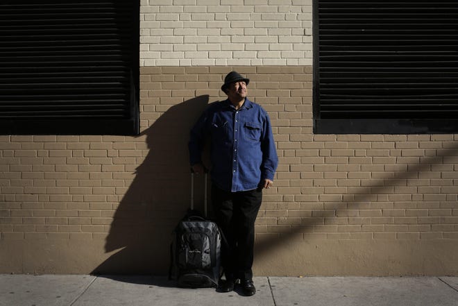 Jessie Thibideaux, 63, stands for a portraits while waiting for the bus in downtown Austin in December. "It’s a bit of a personal thing to take care of other people," Thibideaux says. "I’m the oldest of nine, I’m always taking care of other people. Before I got anything they got it first."  [BRONTE WITTPENN/AMERICAN-STATESMAN]