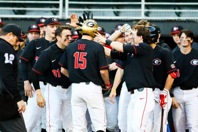 Georgia's Cole Tate receives a spiked helmet after hitting his first career home run on Friday night in the Bulldogs’ season opener. (Photo by Tony Walsh, UGA Sports Communications)