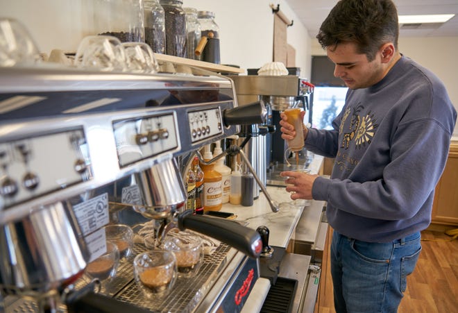 Keaton Sanjur prepares an iced caramel macchiato Friday at his recently opened Keat's Coffee in Ashland.