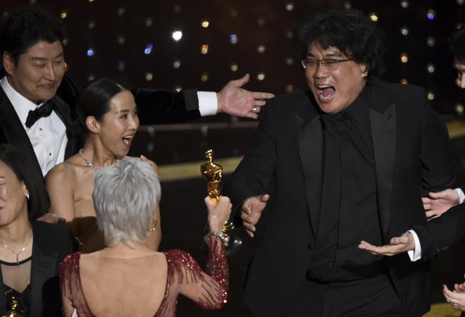 Bong Joon Ho, right, reacts as he is presented with the award for best picture for "Parasite" from presenter Jane Fonda at the Oscars on Sunday, Feb. 9, 2020, at the Dolby Theatre in Los Angeles. Looking on from left are Song Kang-Ho and Kwak Sin Ae. [CHRIS PIZZELLO / AP]