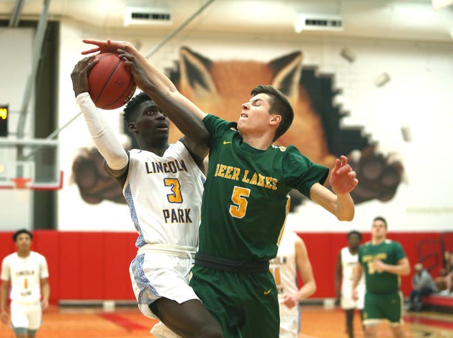 Lincoln Park's Dakari Bradford (3) attempts a layup but is blocked by Deer Lakes Bryce Robson (5) during the first round of the WPIAL Class 3A playoffs at Fox Chapel High School Friday night. [Michael Longo/For BCT]