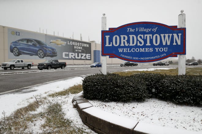 In this Nov. 27, 2018, file photo, a banner depicting the Chevrolet Cruze model vehicle is displayed at the GM Lordstown plant in northeast Ohio. An electric truck manufacturer is hoping to begin production at the closed plant soon -- and a tenuous loan program could help. [AP/John Minchillo]