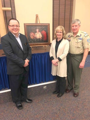 Bud Stebbins, left, of the Commercial and Savings Bank (sponsor of the event) congratulates Jody Frye and Tim Frye on Tim’s recognition as Killbuck District Scouter of the Year.