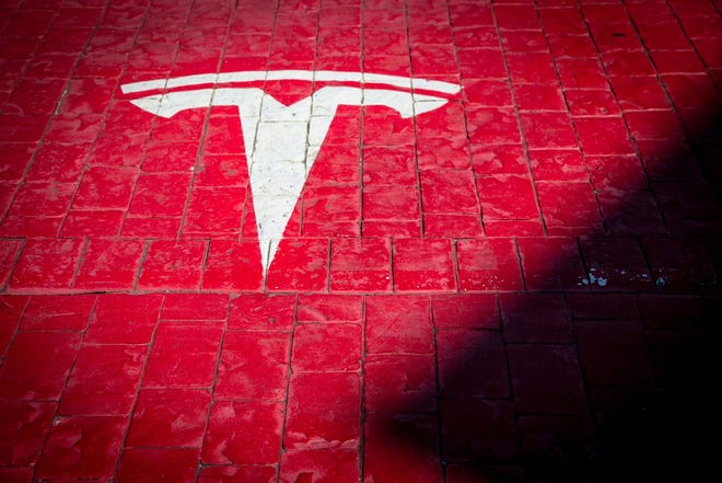 A Tesla logo marks a parking bay at a supercharger station in Girona, Spain. [Bloomberg, file / Angel Garcia]
