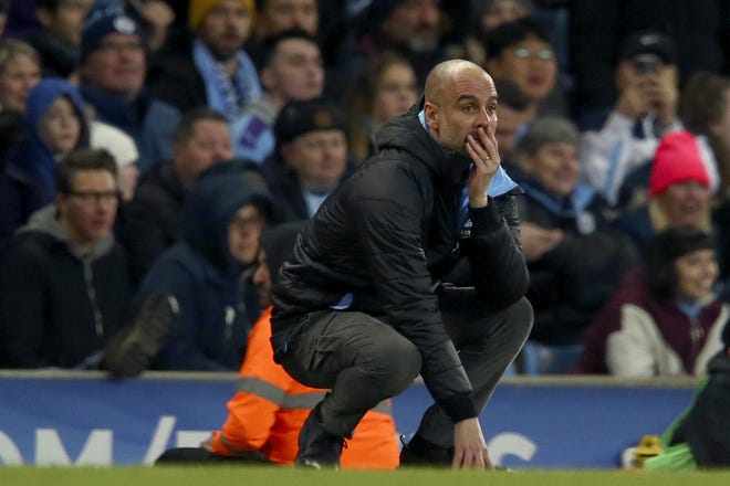 Manchester City's head coach Pep Guardiola reacts after a missed chance to score during the English League Cup semifinal second leg match between Manchester City and Manchester United at Etihad Stadium on Jan. 29 in Manchester, England. [Dave Thompson/The Associated Press]
