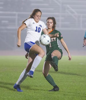 Matanzas sophomore Victoria Wilcox, left, battles Mosley’s Mary Beth Whitlock for the ball in the first half of a girls regional soccer game at Tommy Oliver Stadium Tuesday, Feb. 11, 2020. (MIKE FENDER / FOR THE NEWS HERALD)