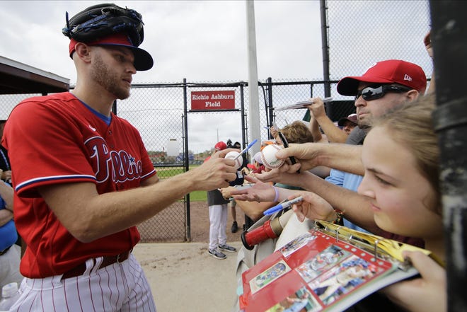 Phillies pitcher Zack Wheeler signs autographs during a spring training workout Friday in Clearwater. [FRANK FRANKLIN / ASSOCIATED PRESS]