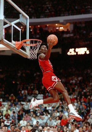FILE - In this Feb. 6, 1988, file photo, Chicago Bulls' Michael Jordan dunks during the slam-dunk competition of the NBA All-Star weekend in Chicago. Jordan left the old Chicago Stadium that night with the trophy. To this day, many believe Wilkins was the rightful winner. (AP Photo/John Swart)