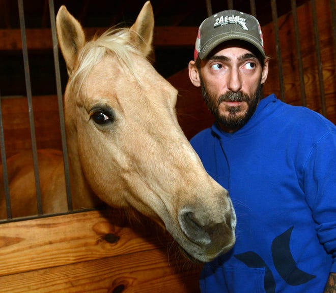Randy Courtmanche, 42, of Chepachet, R.I., talks last week about being molested when he was a Boy Scout in Thompson. He cares for Sandy, a palomino quarter horse, and other horses and amimals in Chepachet, R I. [photos by John Shishmanian/ NorwichBulletin.com]