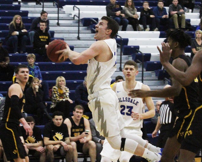 Connor Hill (11) leaps through a pack of Ohio Dominican University defenders during Saturdays Hillsdale College menþÄôs basketball game. [SAM FRY PHOTO].