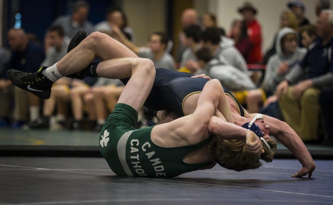 Pope John's Cosmo Esposito, top, battles with Camden Catholic's Cody Walsh during their 145-pound match of the Non-Public B Final on Sunday at Toms River North High School in Toms River. Walsh won with a fall at 2:47 to help the Fighting Irish defeat the Lions, 51-15. [Photo by Daniel Freel/New Jersey Herald (NJH)]