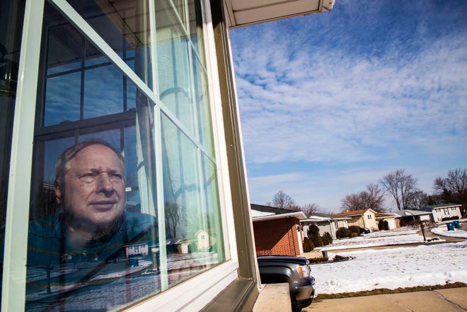 In this Feb. 11, 2020, photo, Ken Zurek, 63, poses for a photo at his home in Highland, Ind. Zurek and his wife arrived in China days before news broke of the coronavirus. They cut their trip short because of the virus and decided to self quarantine themselves in their Highland home for 15 days, just as an extra precaution.
