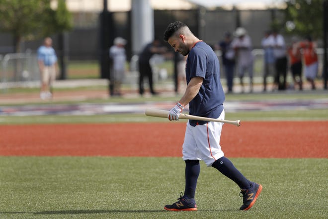 Jose Altuve, preparing to take some batting practice last week, heard the taunt “Cheater” from a fan at Monday’s first full-squad workout. [Jeff Roberson/The Associated Press]