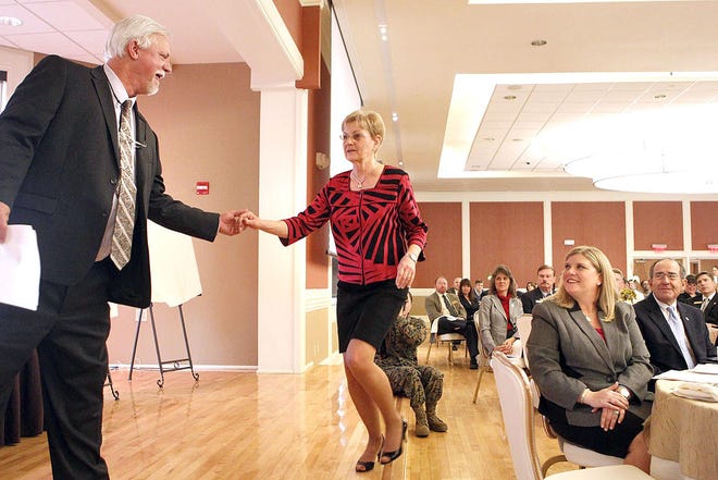 Elliott Potter helps Mona Padrick, recipient of the Order of the Long Leaf Pine, during the 69th Annual Jacksonville-Onslow Chamber of Commerce Membership Celebration in 2013. [Don Bryan / The Daily News]