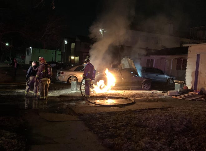 Topeka Fire Department crews extinguish a car blaze around 5:30 a.m. Monday at S.W. 9th and Polk.