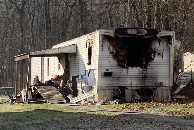 A man and a toddler were rescued from a fire at this mobile home at 328 E. High St. in Uhrichsville on Monday morning. (TimesReporter.com / Hank Keathley)