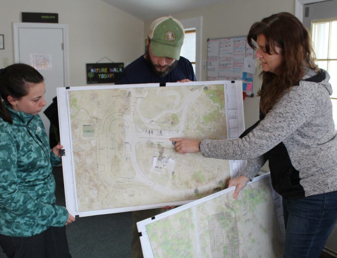 Mount Agamenticus Conservation Coordinator Robin Kerr, joined by York Parks & Recreation staffers, points to a drawing for planned traffic flow improvements at the summit of the mountain on Feb. 10, 2020. The drawing is part of $1.2 million in projects proposed for the site. [Steven Porter/Seacoastonline]