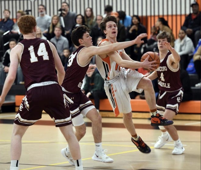 Wayland High senior captain Jack Melvin drives around a Concord-Carlisle player during a game last month. Melvin scored a career-high 41 points in the Warriors' 73-58 win over Weston Friday night. [Daily News and Wicked Local Staff File Photo/John Walker]