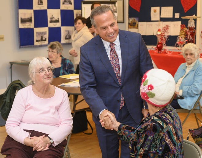 Rep. David N. Cicilline talks with Holly Phillips of Middletown during a visit to the Middletown Senior Center to talk about his work to lower prescription drug costs, Tuesday in Middletown. Looking on is Marilyn Murphy of Middletown [DAVE HANSEN PHOTO]