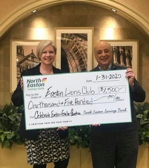 Cortney Palm of the North Easton Savings Bank recently presented Easton Lion Bob Grella with a $1,500 sponsorship check for the Lions Celebration of Easton event March 7. [Courtesy Photo]
