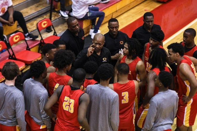 The Clarke Central boys basketball team huddles up during the Region 8-5A tournament game. The Gladiators beat Eagle’s Landing Thursday to advance to the Class 5A quarterfinals. (Photo/Gabriella Audi, for the Banner-Herald)