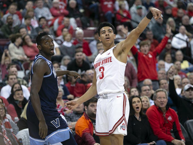 Ohio State guard D.J. Carton shoots a three-pointer against Villanova forward Dhamir Cosby-Roundtree during a game at Value City Arena on Nov. 13. Carton took an indefinite leave of absence on Jan. 30. [Adam Cairns/Dispatch]