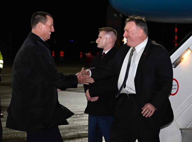 Secretary of State Mike Pompeo is greeted by U.S. ambassador to Germany Richard Grenell as he arrives at Munich International Airport, in Munich, Germany on Thursday, February 13, 2020. (Andrew Caballero-Reynolds/Pool via AP)